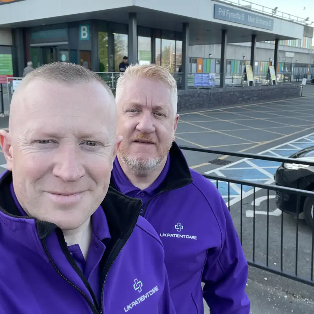 Two UK Patient Care staff arriving at a Patient Bed Watching location