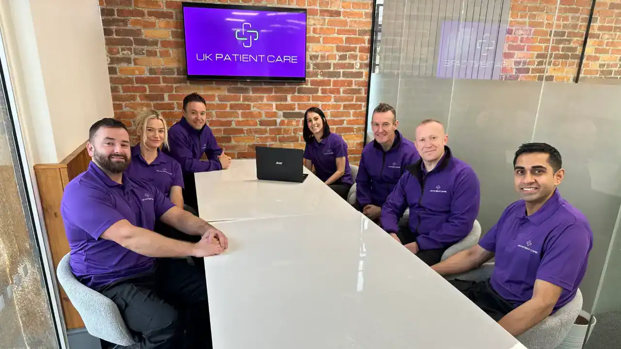 UK patient Care staff at meeting table.